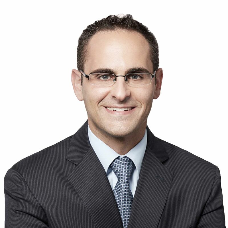 Andrew Bratt seen in a white color shirt and black color suit